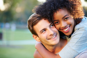 Younger couple smiling after LASIK