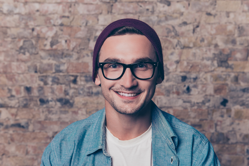 Man staring into camera with new glasses. 