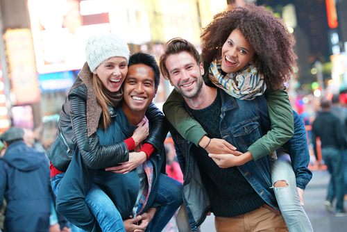 Two happy young couples in Times Square