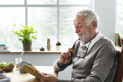 Older man reading about cataract surgery